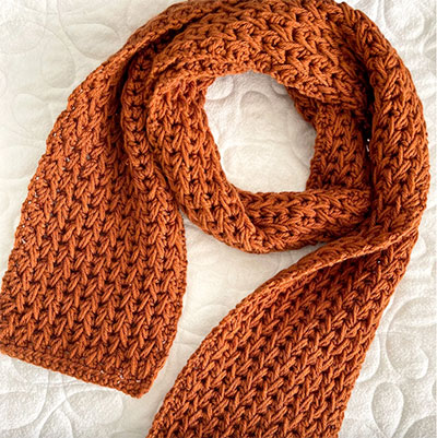 how to crochet the feather stitch photo of a scarf from an alternate angle against a white background 