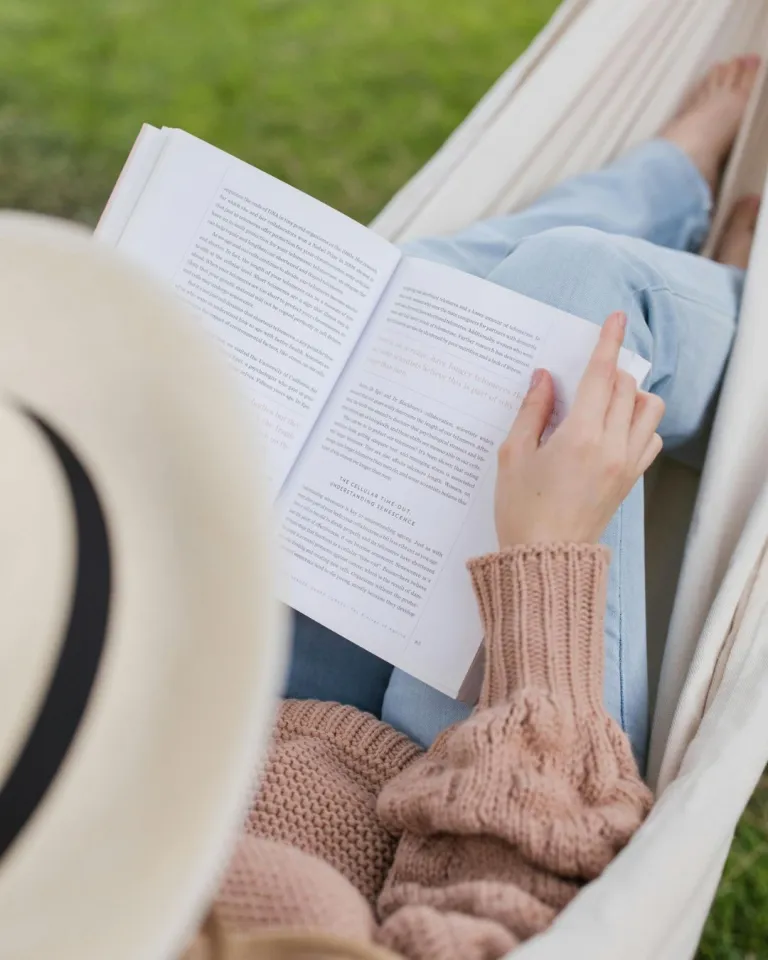 5 sunday self care ideas photo of a woman reading in a hammock 