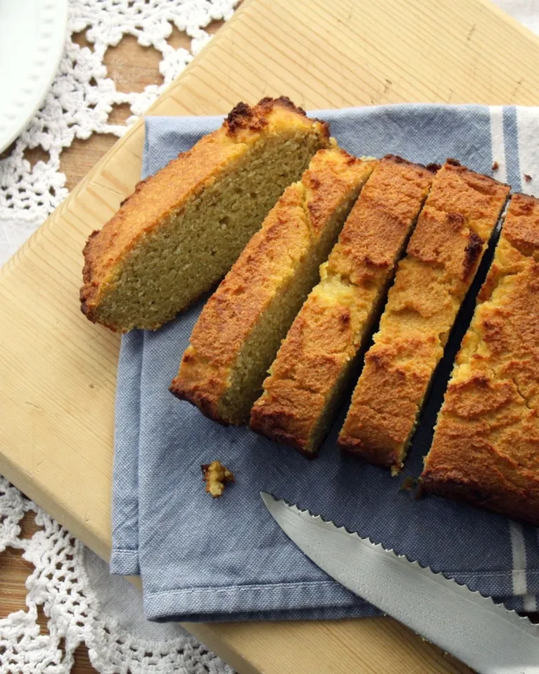cooking from scratch photo of homemade corn bread on a cutting board that has been cut 