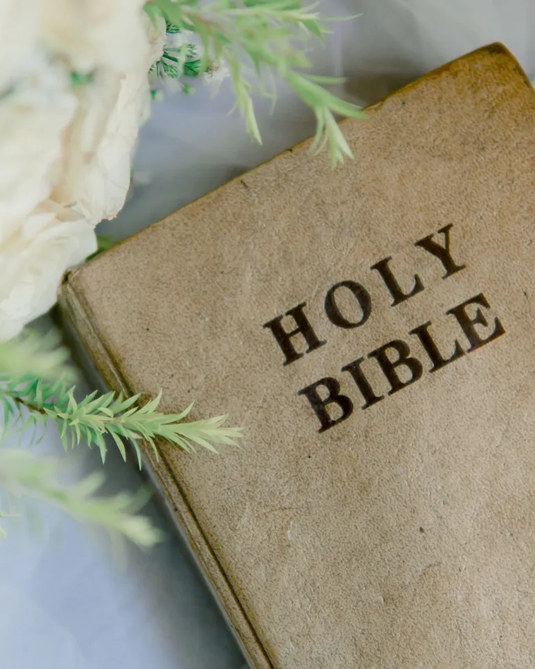 living as christ taught photo of a bible on a grey background 
