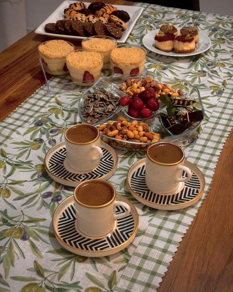 hospitality begins before the guest arrive photo of coffee, fruit and dessert on a wooden table surface 