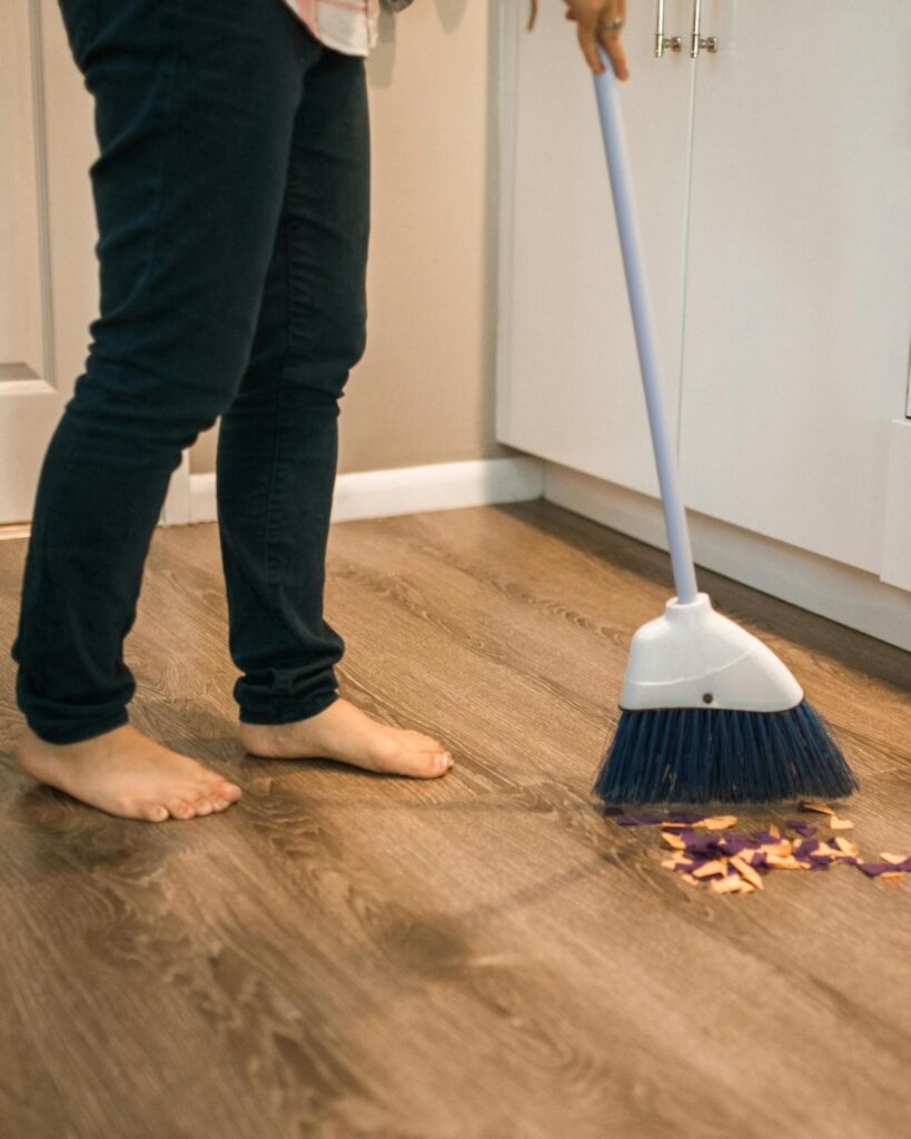 photo of a woman sweeping the floor homemaking feeling overwhelming photo
